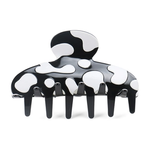 Chic black and white cow print acetate hair claw clip with glossy finish for women