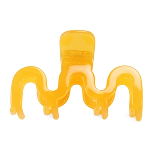 Dettaglio della pinza per capelli a onde giallo brillante in acetato con finitura lucida