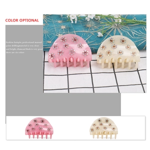 Elegant semi-round acrylic hair claws with rhinestone flowers in pink and cream beige