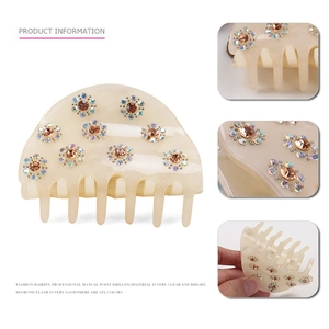 Acrylic hair claw clip with colorful rhinestones in a semi-circle floral design
