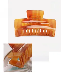 Detailed specs of cellulose acetate hair claw with amber finish, size 7.6x3.6cm