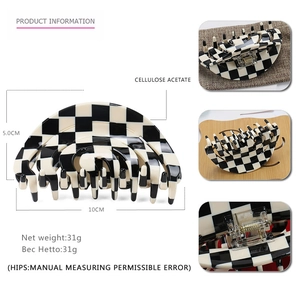 Detailed view of large black and white checkerboard hair claw clip with size measurements