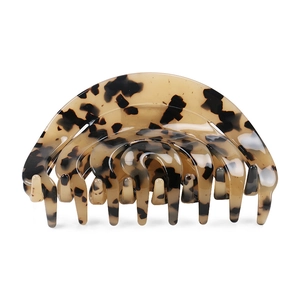 Close-up of tortoise shell leopard pattern hair claw clip with vintage acetate finish