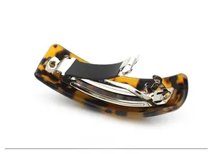 Detail view of leopard print acetate hair clip with silver spring metal mechanism