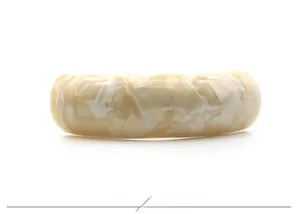 Detail of elegant cream white marble acetate hair clip with natural smooth texture