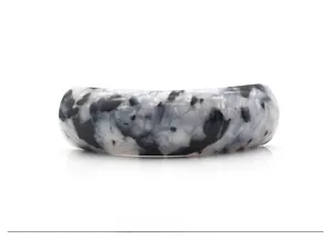 Detailed view of polished black and white marble acetate hair clip with u-shaped design