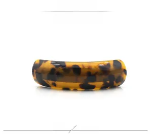 Detailed view of the leopard print acetate hair clip featuring a polished u-shape design
