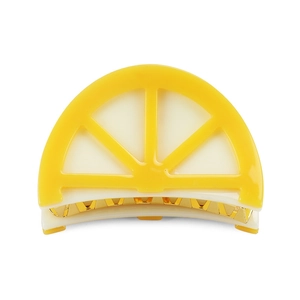 Macro shot of lemon slice hair claw clip with golden metal teeth and yellow resin detail