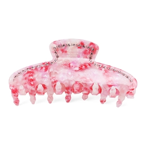 Close-up of pink marbled acetate hair claw clip with sparkling rhinestones details