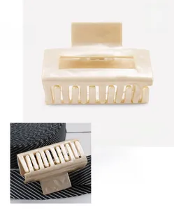 Detail view of pearlescent beige acetate hair claw clip with 6.7x4.2cm dimensions