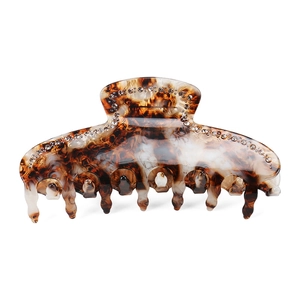 Close-up of tortoise shell acetate hair claw clip with shimmering rhinestone details