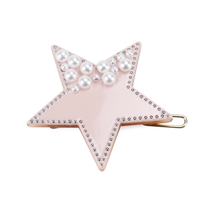 Close-up of pink star-shaped hair clip with white pearls and silver beaded trim