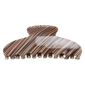 Macro detail of large acetate hair claw clip featuring brown striped patterns and smooth teeth