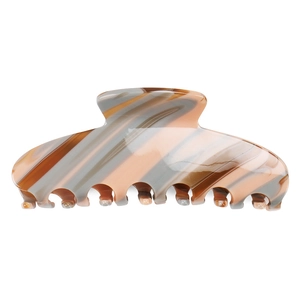 Detail of large acetate hair claw clip featuring brown marble striped texture finish