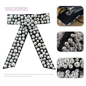 Elegant velvet bow hair clip with pearl embellishments and metal spring fastener