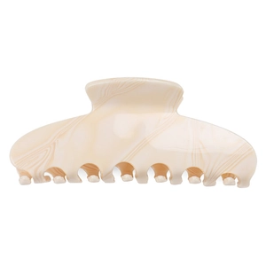 Detailed macro view of large acetate hair claw with cream marble wave pattern