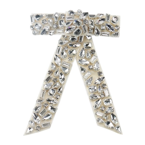 Sparkling crystal bow hair clip with luxury rhinestones in elegant off-white