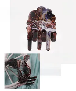 Detail view of acetate hair claw with rhinestones showing 5.3x4.5cm dimensions