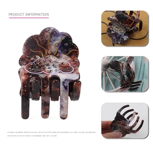 Elegant tortoiseshell acetate hair claw clip with purple marble patterns and crystal rhinestones