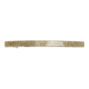 Detailed view of long gold glitter acrylic hair clip with a sparkling textured surface
