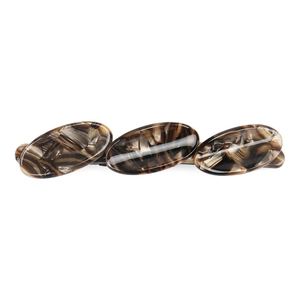 Detailed close-up of French acetate hair clip featuring three oval tortoiseshell patterns