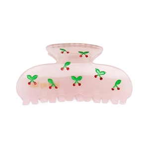 Detailed view of pink translucent cherry hair claw clip with sparkling red rhinestones