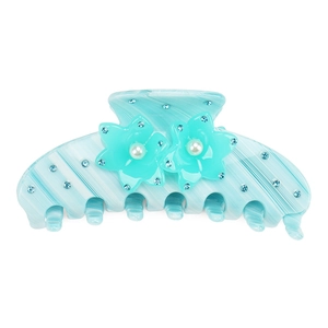 Detail of blue acetate hair claw clip featuring inlaid pearls and sparkling floral crystals