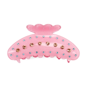 Détail de la pince à cheveux en résine rose avec poudre dorée et strass colorés