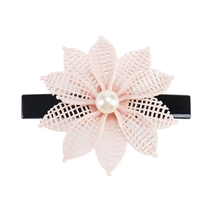 Close-up of pink flower hair clip with mesh texture and faux pearl detail