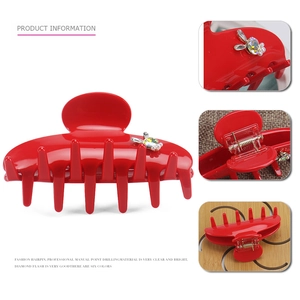 Red acetate hair claw with crystal rabbit and pearls on a white background