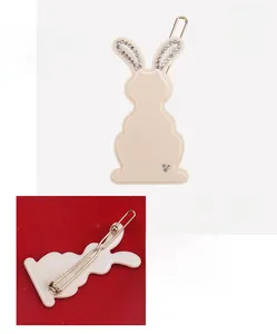 Detail view of cellulose acetate rabbit hair clip with rhinestones and metal clip