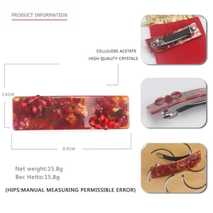 Detail view showing 8.9cm large acetate spring hair clip with red crystal flower design