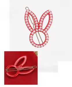 Detailed view of red rabbit acetate hair clip with pearls measuring 5.2 by 3.4 cm