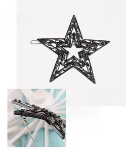 Detailed view of star-shaped acetate hair clip with crystals and size specifications
