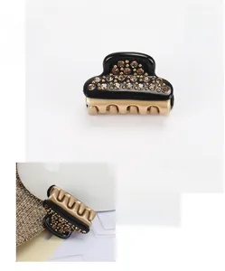 Detail of mini black acetate hair claw with brown Austrian crystals and gold-tone base