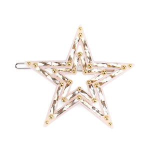 Detailed close-up of a pink star hair clip with champagne rhinestones and gold beads