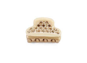 Detailed macro view of small cream acetate hair claw clip with crystals and golden accents