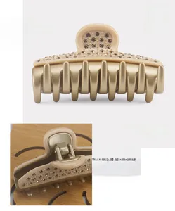 Detailed macro view of French style large hair claw clip with premium sparkling crystals