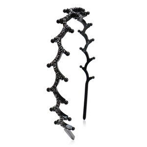 Detail of black wavy acetate headband with micro-paved rhinestones and non-slip design