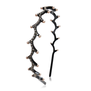 Close-up of black wavy headband decorated with artificial pearls and rhinestones
