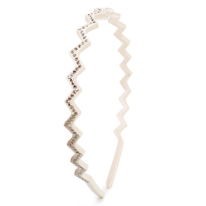 Macro view of cream white wavy headband featuring premium rhinestones on acetate material