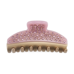 Close-up of pink crystal embellishments on a premium acetate hair claw with gold metal clip
