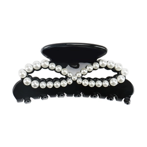 Glossy black acetate hair claw clip with elegant infinity pearl arrangement on white background