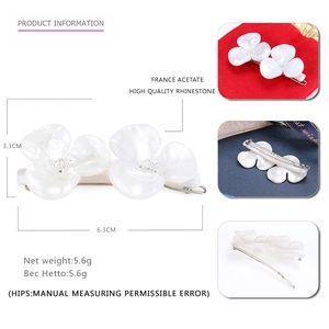 Elegant white floral hair clip made of acetate with rhinestones, sized 6.3cm by 3.3cm