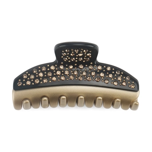 Macro detail of luxury crystal hair claw clip with black and brown resin finish