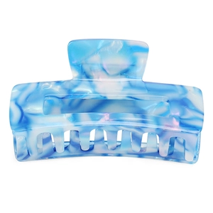 Close-up of blue and white marble pattern acetic acid hair claw clip with multi-tooth grip