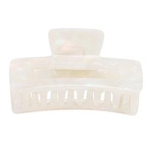 Detail view of the pearl white acetate claw clip featuring a hollow rectangular design
