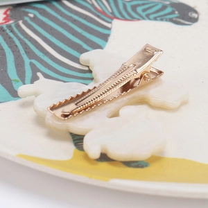 Retro teddy dog puppy hair clip in cream white acrylic with a gold metal jaw duckbill grip