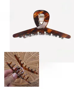 Detail showing cellulose acetate hair claw clip measurements of 10.5cm and 16.5g weight