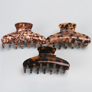 Close-up of tortoise shell and amber marble hair claws with strong metal springs
